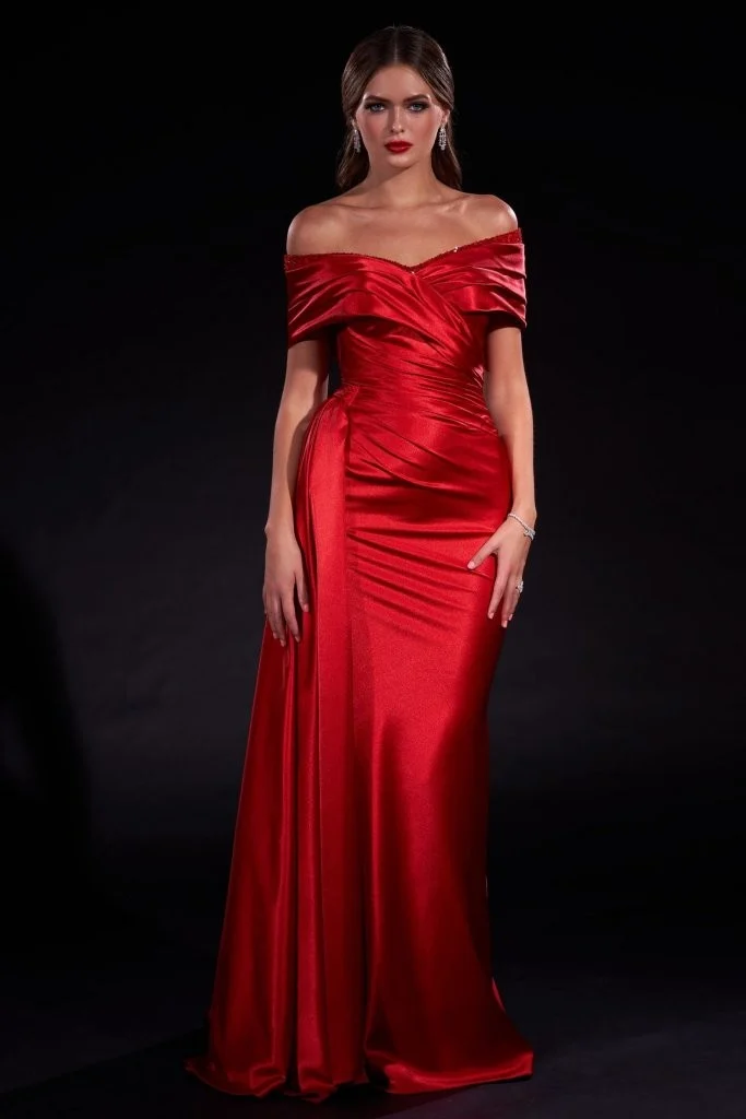 Woman in a red off-shoulder satin couture gown with side drape detail