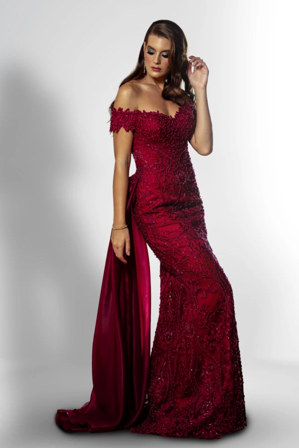 A woman wearing a maroon evening dress