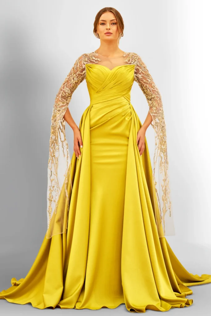 Woman in a yellow gown with lace sleeves.