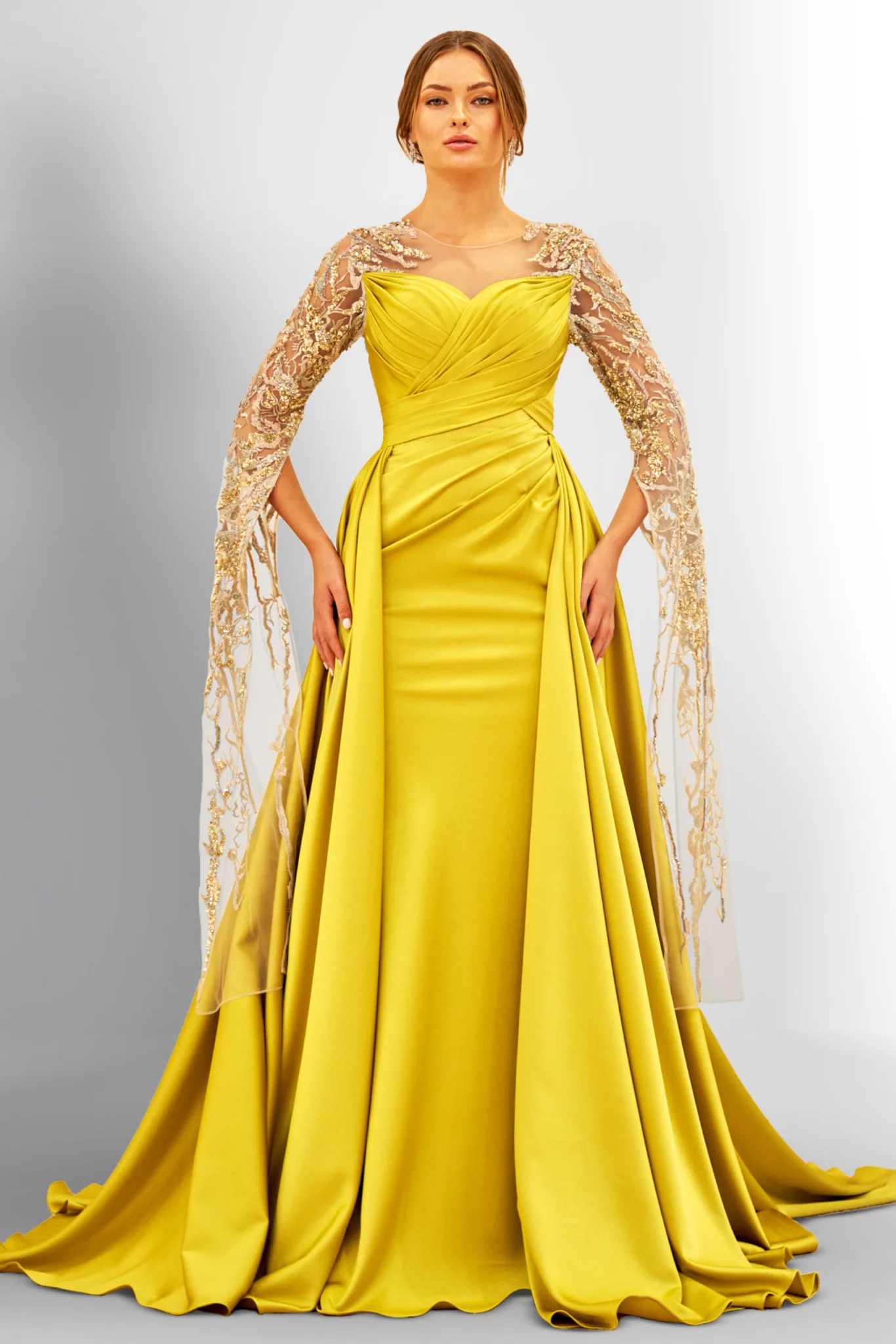 Woman in a yellow gown with lace sleeves.