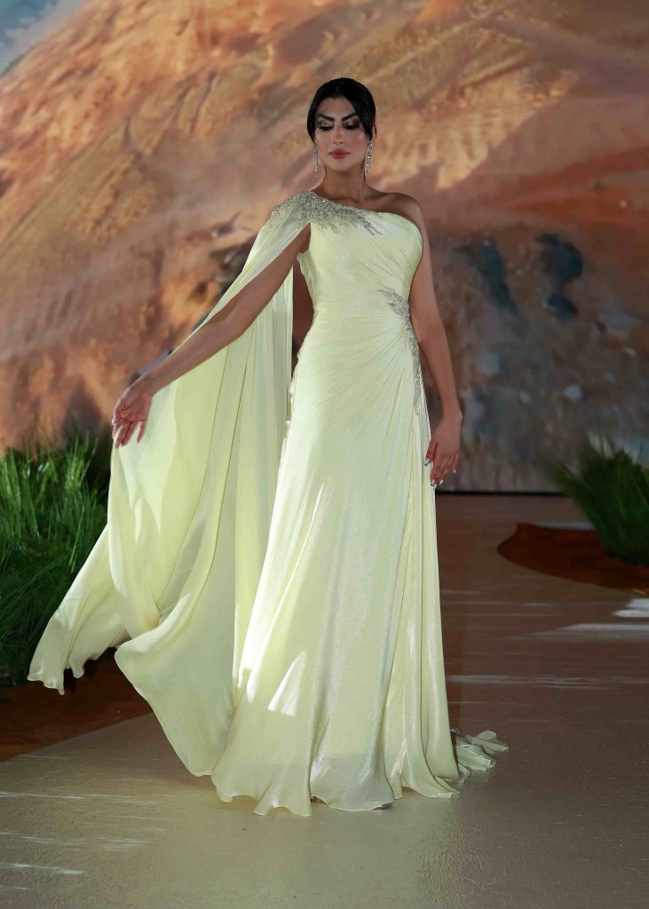Elegant woman in a yellow gown on the Dubai runway